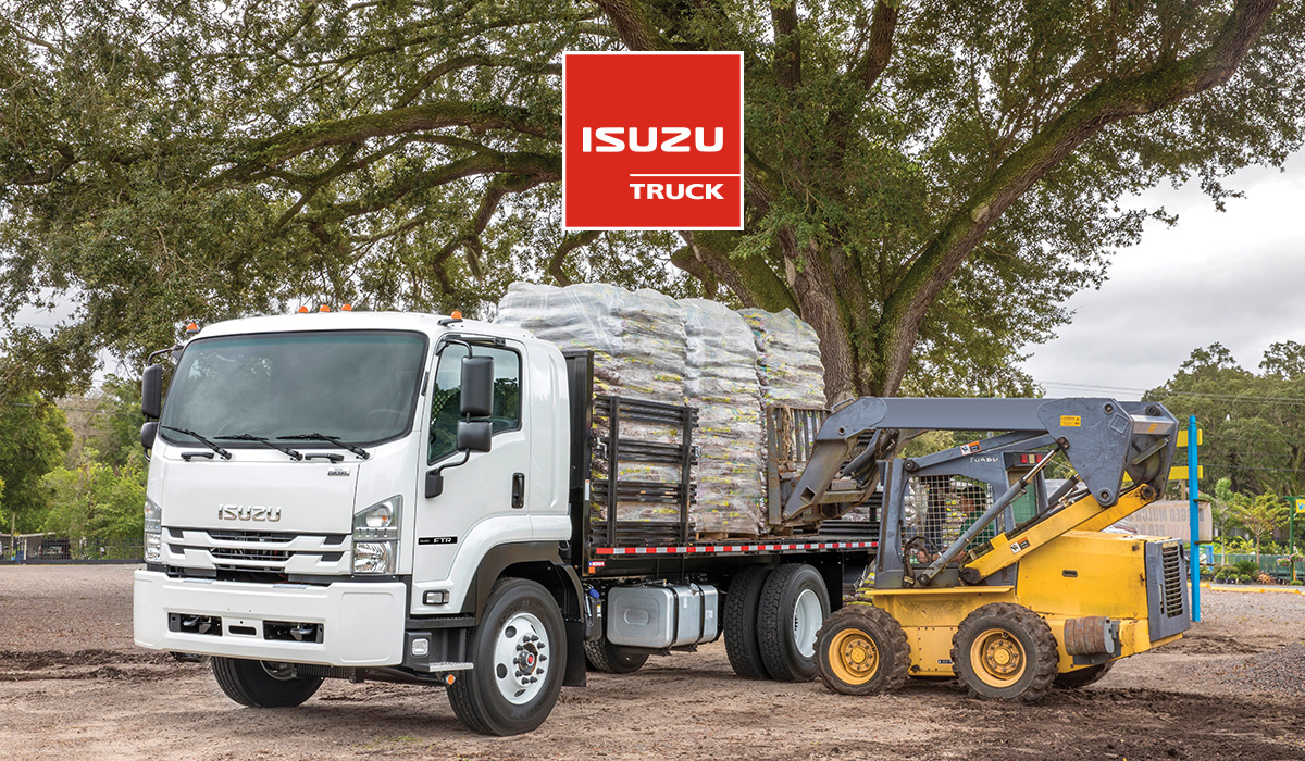 Photo of skid steer loading bags onto Isuzu landscape truck